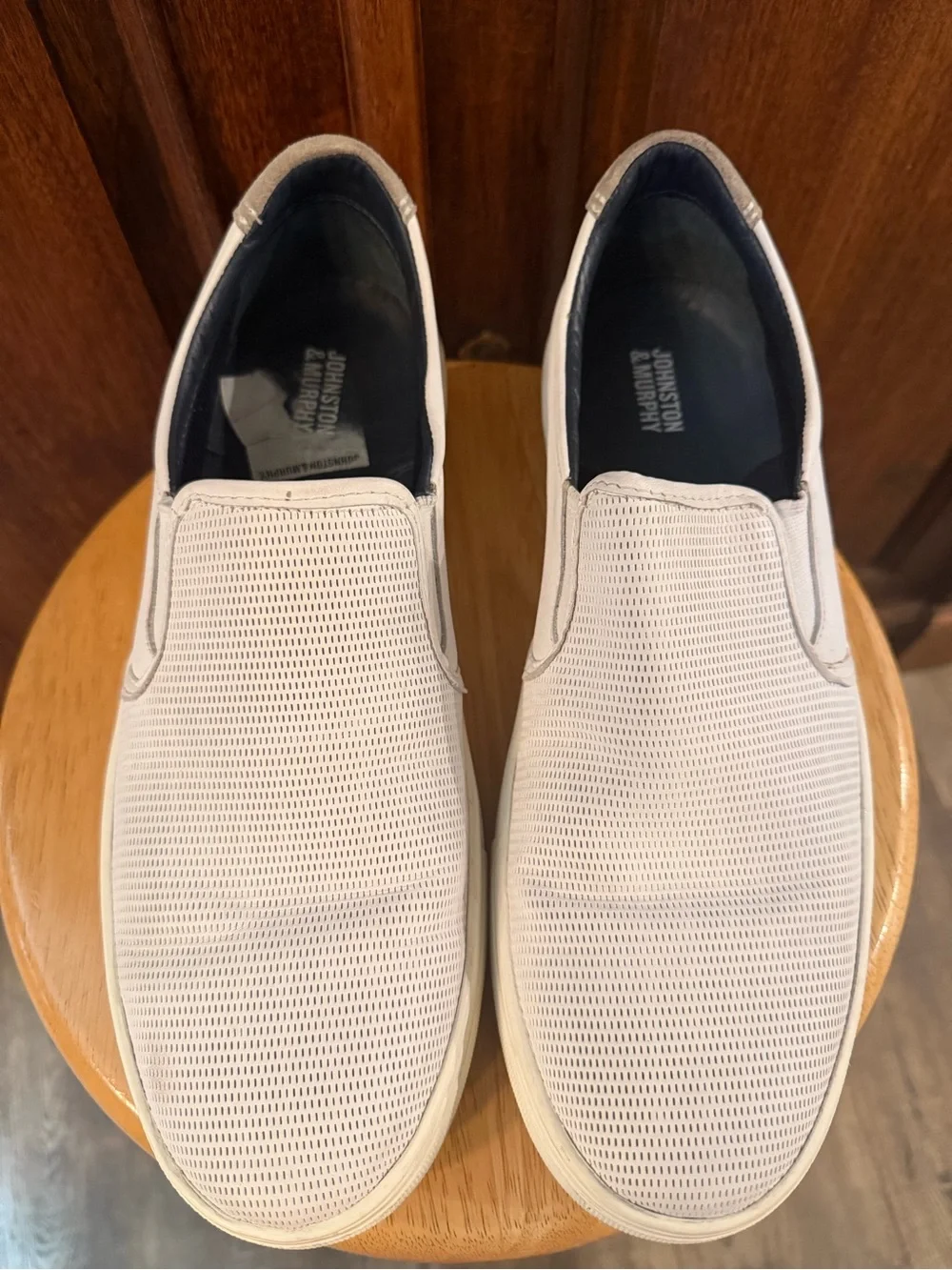 Johnston & Murphy slip-on sneakers featuring a white perforated leather upper 10
